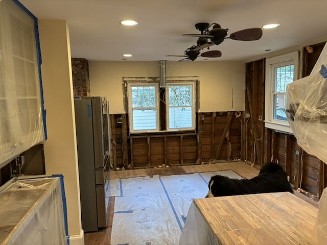 Photo of kitchen stripped down to studs.,